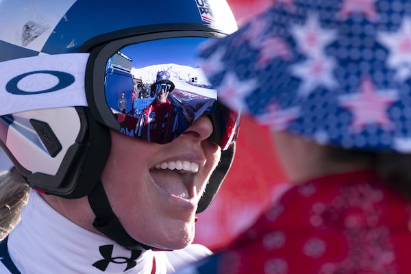 United States' Lindsey Vonn, right, smiles after completing an alpine ski, women's World Cup super G, in St. Moritz, Switzerland, Saturday, Dec. 21, 2024. (Til Buergy/Keystone via AP)