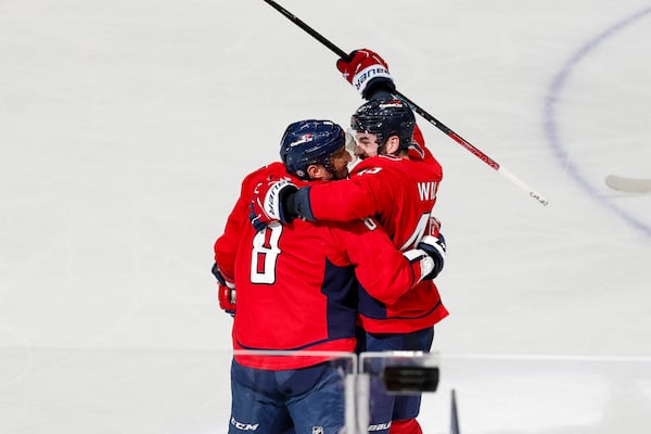 Washington Capitals left wing Alex Ovechkin (8) celebrates his 886th goal with right wing Tom Wilson during the third period of an NHL hockey game against the Seattle Kraken, Sunday, March 9, 2025, in Washington. (AP Photo/Terrance Williams)