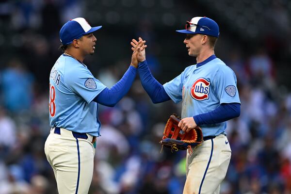 Chicago Cubs closing pitcher Daniel Palencia, left, celebrates with teammate Pete Crow-Armstrong, right, after defeating the Philadelphia Phillies in a baseball game Friday, April 25, 2025, in Chicago. (AP Photo/Paul Beaty)