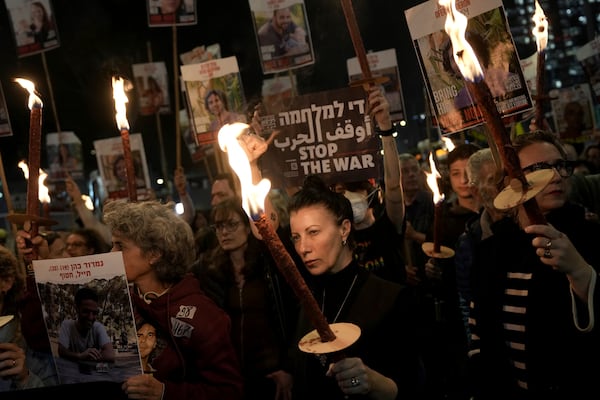 Relatives and friends of people killed and abducted by Hamas and taken into Gaza, react to the ceasefire announcement as they take part in a demonstration in Tel Aviv, Israel, Wednesday, Jan. 15, 2025. (AP Photo/Oded Balilty)