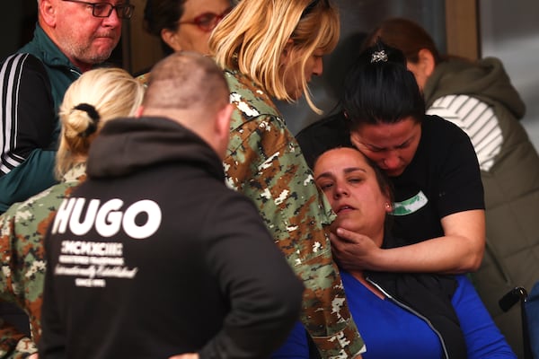 A woman is comforted outside a hospital in the town of Kocani, North Macedonia, Sunday, March 16, 2025, following a massive fire in the nightclub early Sunday. (AP Photo/Armin Durgut)