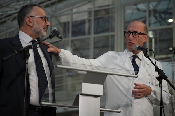 Surgeon Sergio Alfieri, right, and head physician of the Vatican's health and hygiene office, Luigi Carbone speak to journalists, Friday, Feb. 21, 2025, in the entrance hall of Rome's Agostino Gemelli Polyclinic where Pope Francis is being treated for pneumonia. (AP Photo/Alessandra Tarantino)