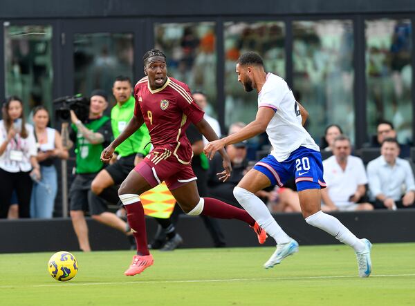 Venezuela forward Jan Hurtado (9) races ahead of United States defender George Campbell (20) during the first half of an international friendly soccer game, Saturday, Jan 18, 2025, in Fort Lauderdale, Fla. (AP Photo/Michael Laughlin)