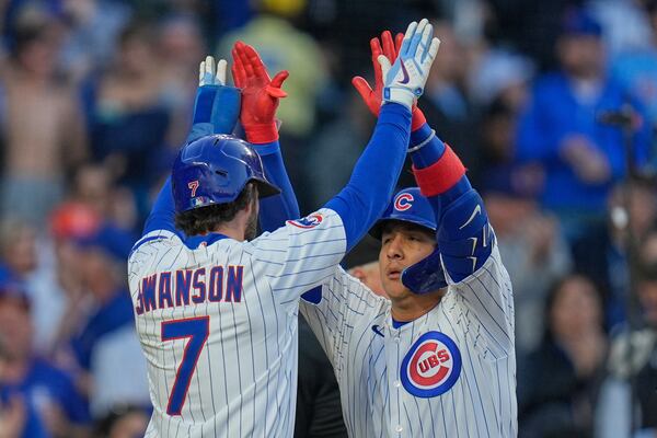 Chicago Cubs' Miguel Amaya (9), right, high-fives Dansby Swanson after Amaya hit a two-run home run during the third inning of a baseball game against the San Francisco Giants, Tuesday, May 6, 2025, in Chicago. (AP Photo/Erin Hooley)