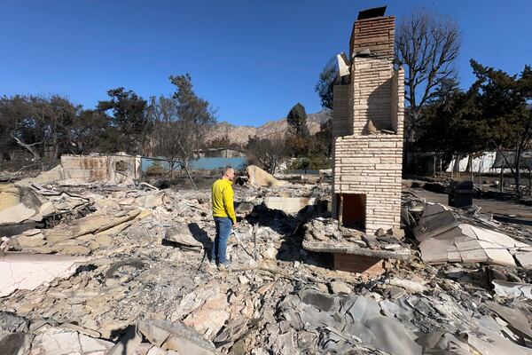 Ryan Pearson, a Los Angeles-based entertainment video editor for The Associated Press, surveys his home that was destroyed by the Eaton Fire, Wednesday, Jan. 15, 2025, in Altadena, Calif. (AP Photo/Ryan Pearson)