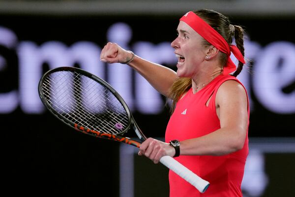 Elina Svitolina of Ukraine celebrates after defeating Jasmine Paolini of Italy in their third round match at the Australian Open tennis championship in Melbourne, Australia, Saturday, Jan. 18, 2025. (AP Photo/Vincent Thian)