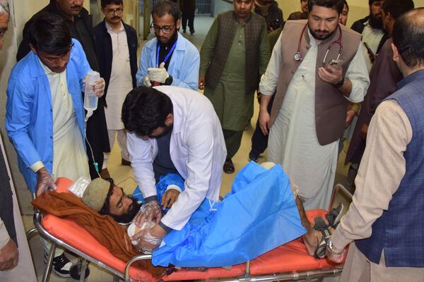 An injured victim of a passenger train attacked by insurgents, receives treatment upon arrival at a hospital in Quetta, Pakistan's southwestern Balochistan province, Thursday March 13, 2025. (AP Photo/Arshad Butt)