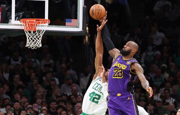 Boston Celtics center Al Horford (42) defends the net on a score attempt by Los Angeles Lakers forward LeBron James (23) during the second half of an NBA basketball game, Saturday, March 8, 2025, in Boston. (AP Photo/Mark Stockwell)