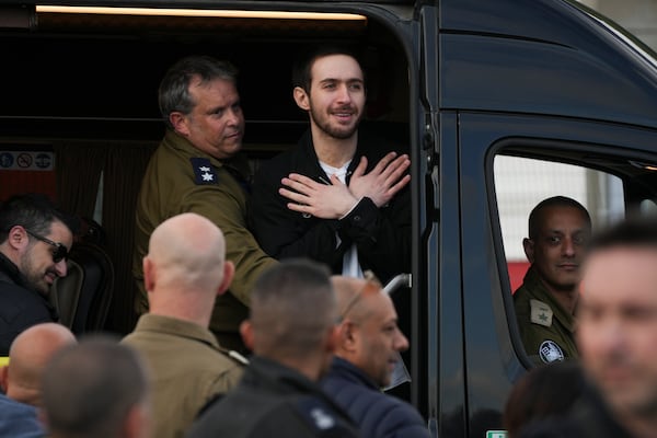 Freed Israeli hostage Omer Shem Tov gestures from a van as he arrives at Beilinson hospital in Petah Tikva, Israel, after he was released from Hamas captivity in the Gaza Strip, Saturday, Feb. 22, 2025. (AP Photo/Ohad Zwigenberg)