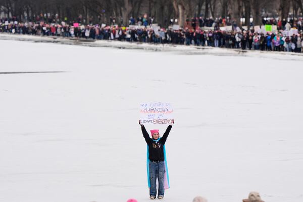 A person holds a sign during the People's March, Saturday, Jan. 18, 2025, in Washington. (AP Photo/Mike Stewart)