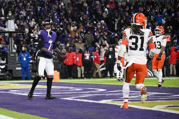 Baltimore Ravens wide receiver Rashod Bateman (7) celebrates after catching a 7-yard touchdown pass Cleveland Browns' Mike Ford Jr. (31) and Mohamoud Diabate, right, stand by during the second half of an NFL football game Saturday, Jan. 4, 2025, in Baltimore. (AP Photo/Nick Wass)