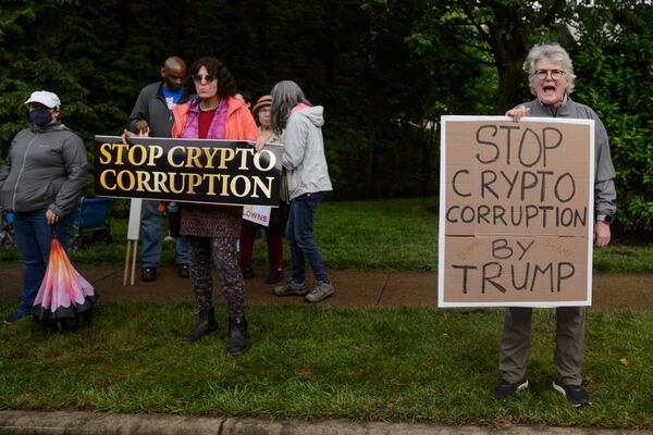 Demonstrators protest near Trump National Golf Club Washington DC before the arrival of President Donald Trump in Sterling, Va., Thursday, May 22, 2025. (AP Photo/Rod Lamkey, Jr.)