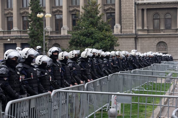 Police in riot gear protect the office of the president of Serbia during a major anti-corruption rally led by university students in Belgrade, Serbia, Saturday, March 15, 2025. (AP Photo/Marko Drobnjakovic)