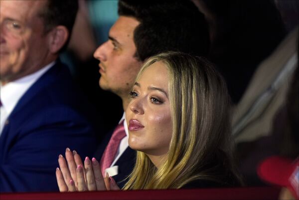 FILE - Tiffany Trump and her husband, Michael Boulos, listen as Republican presidential nominee former President Donald Trump speaks at a campaign rally at Williams Arena at Mignes Coliseum, Oct. 21, 2024, in Greenville, N.C. (AP Photo/Julia Demaree Nikhinson, File)