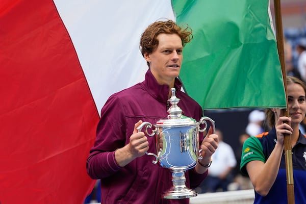 FILE - Jannik Sinner, of Italy, holds up the championship trophy after defeating Taylor Fritz, of the United States, in the men's singles final of the U.S. Open tennis championships, Sunday, Sept. 8, 2024, in New York. (AP Photo/Julia Nikhinson, File)