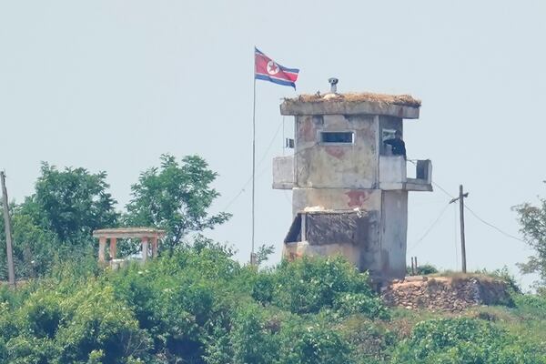 FILE - A soldier stands at a North Korean military guard post flying a national flag, seen from Paju, South Korea, June 26, 2024. (AP Photo/Lee Jin-man, File)