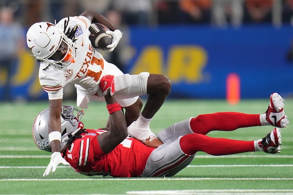 Texas wide receiver Silas Bolden (11) runs against Ohio State cornerback Denzel Burke during the first half of the Cotton Bowl College Football Playoff semifinal game, Friday, Jan. 10, 2025, in Arlington, Texas. (AP Photo/Julio Cortez)