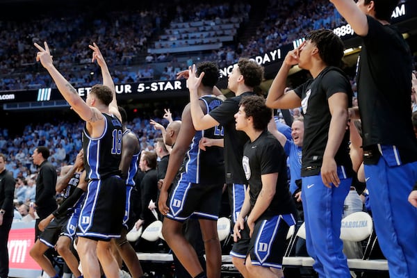 Players on the bench celebrate a basket by the team on the floor during the second half of an NCAA college basketball game against North Carolina, Saturday, March 8, 2025, in Chapel Hill, N.C. (AP Photo/Chris Seward)