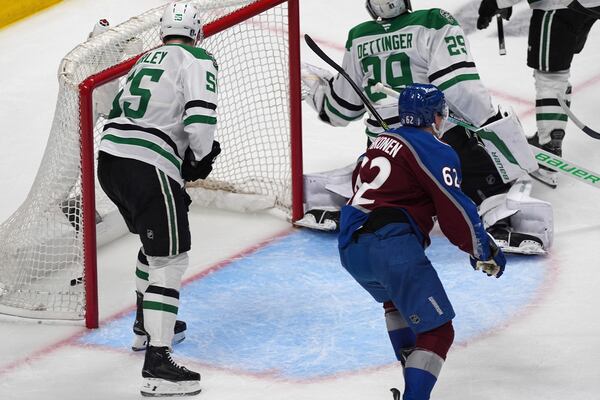Colorado Avalanche left wing Artturi Lehkonen, front right, reacts after the puck went in the net past Dallas Stars goaltender Jake Oettinger, back right, as defenseman Thomas Harley looks on for the go-ahead goal awarded to Colorado's Nathan MacKinnon in the third period of Game 6 of an NHL first-round hockey playoff series Thursday, May 1, 2025, in Denver. (AP Photo/David Zalubowski)