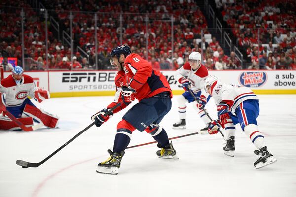 Washington Capitals left wing Alex Ovechkin (8) skates with the puck past Montreal Canadiens defenseman Lane Hutson (48) in the first period of Game 5 of a first-round NHL hockey playoff series Wednesday, April 30, 2025, in Washington. (AP Photo/Nick Wass)