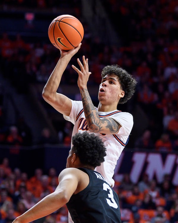 Illinois' Will Riley shoots over Michigan State's Jaden Akins during an NCAA college basketball game Saturday, Feb. 15, 2025, in Champaign, Ill. (AP Photo/Craig Pessman)