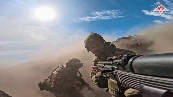 In this photo taken from video distributed by Russian Defense Ministry Press Service on Monday, May 12, 2025, Russian servicemen attend a combat training for assault units in an undisclosed location in Ukraine. (Russian Defense Ministry Press Service via AP)