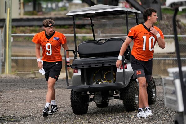 Cincinnati Bengals quarterbacks Joe Burrow, left, and Payton Thorne, arrive for NFL football practice, Tuesday, May 20, 2025, in Cincinnati. (AP Photo/Carolyn Kaster)