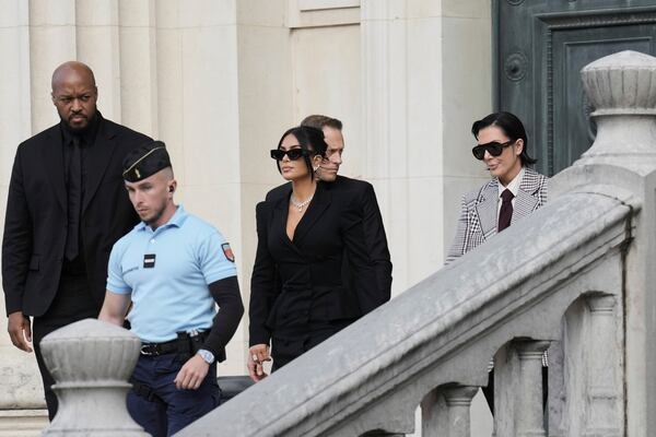 Kim Kardashian, center, accompanied by her mother Kris Jenner, right, leaves the justice palace after testifying, regarding a robbery of millions of dollars in jewels from her Paris hotel room in 2016, in Paris, Tuesday, May 13, 2025. (AP Photo/Aurelien Morissard)