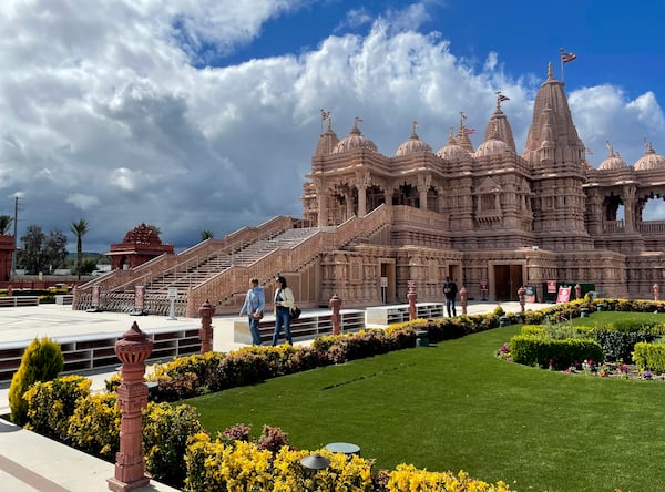 Visitors walk in front of the BAPS Shri Swaminarayan Mandir, the largest Hindu temple in California, on Thursday, March 13, 2025. (AP Photo/Deepa Bharath)