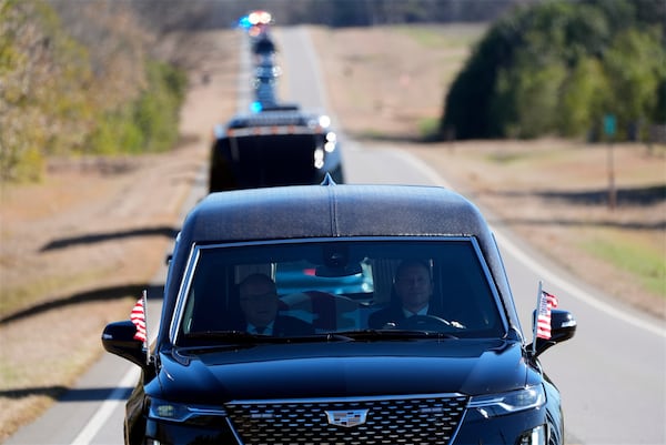 The hearse containing the casket of former President Jimmy Carter moves toward Plains, Ga., Saturday, Jan. 4, 2025. Carter died Dec. 29 at the age of 100. (AP Photo/Alex Brandon, Pool)