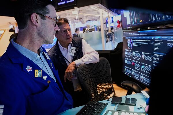 Specialist John McNierney, left, and trader Anthony Carannante work on the floor of the New York Stock Exchange, Wednesday, May 14, 2025. (AP Photo/Richard Drew)