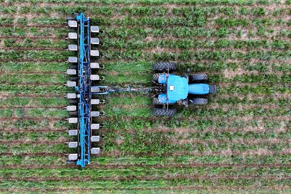 In this image from video provided by Matt Griggs, a tractor plants seeds in the ground on April 21, 2025 on the farm of Matt Griggs in Humboldt, Tenn. Griggs, like many American farmers, is paying close attention to the trade war between the U.S. and China, a critical market for soybeans. (Matt Griggs via AP)