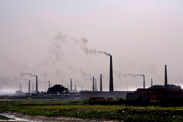 Smoke rises from chimneys of brick kilns on the outskirts of Dhaka, Bangladesh, on Feb. 9, 2025. (AP Photo/Mahmud Hossain Opu)