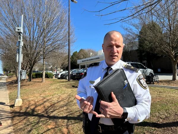 Decatur Police Chief Scott Richards discusses an automated speed camera outside Beacon Hill Middle School in Decatur, Ga., on Tuesday, Feb. 25, 2025. (AP Photo/Jeff Amy)