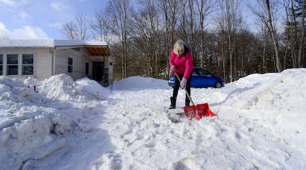 Janis Broom shovels the snow from her driveway on Monday, Feb. 17, 2025, Brattleboro, Vt., after a winter storm on Sunday. (Kristopher Radder/The Brattleboro Reformer via AP)