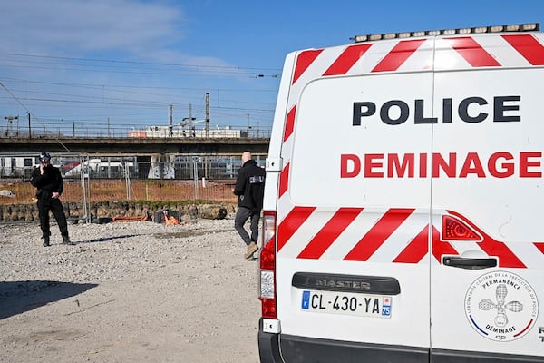 This photo provided by the Paris Police Prefecture shows police disposal officers near a huge unexploded World War II-era bomb that caused transportation chaos in Paris, that included the suspension of high-speed rail links with London and Brussels and the closure of a vital road artery in the French capital Friday, March 7, 2025 in Saint-Denis, outside Paris. (Prefecture de Police via AP)