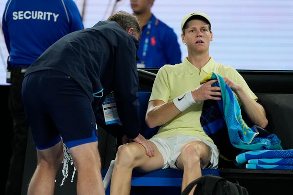 Jannik Sinner of Italy receives medical treatment during his semifinal match against Ben Shelton of the U.S. at the Australian Open tennis championship in Melbourne, Australia, Friday, Jan. 24, 2025. (AP Photo/Ng Han Guan)