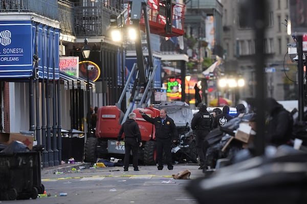 Emergency services attend the scene on Bourbon Street after a vehicle drove into a crowd on New Orleans' Canal and Bourbon Street, Wednesday Jan. 1, 2025. (AP Photo/Gerald Herbert)