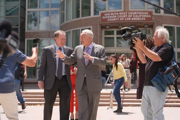 Attorney Mark Geragos, center, who represents Erik and Lyle Menendez, leaves the courthouse during break from the brothers' resentencing hearing Tuesday, May 13, 2025, in Los Angeles. (AP Photo/Damian Dovarganes)
