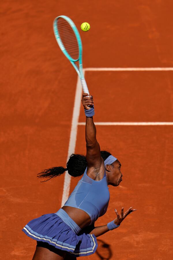 United States' Coco Gauff serves against Iga Swiatek of Poland during the Madrid Open tennis tournament in Madrid, Spain, Thursday, May 1, 2025. (AP Photo/Manu Fernandez)
