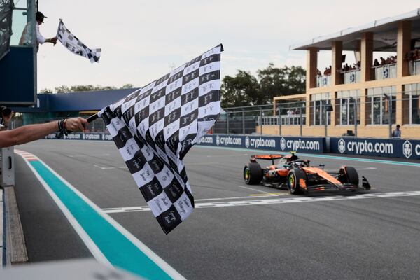 McLaren driver Oscar Piastri of Australia crosses the finish to win the Formula One Miami Grand Prix auto race Sunday, May 4, 2025, in Miami Gardens. Fla. (Shawn Thew/Pool Photo via AP)