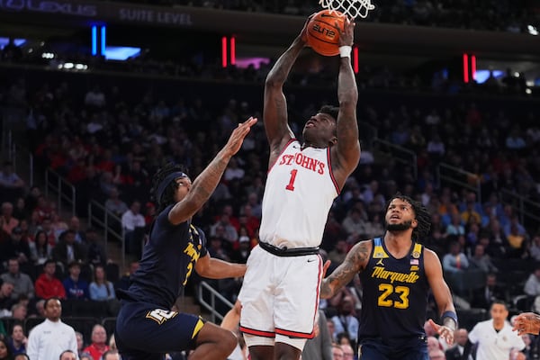 St. John's's Kadary Richmond (1) shoots over Marquette's Chase Ross (2) and David Joplin (23) during the first half of an NCAA college basketball game in the semifinals of the Big East tournament Friday, March 14, 2025, in New York. (AP Photo/Frank Franklin II)