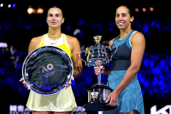 Madison Keys, right, of the U.S. holds the Daphne Akhurst Memorial Cup after defeating Aryna Sabalenka, left, of Belarus in the women's singles final at the Australian Open tennis championship in Melbourne, Australia, Saturday, Jan. 25, 2025. (AP Photo/Asanka Brendon Ratnayake)