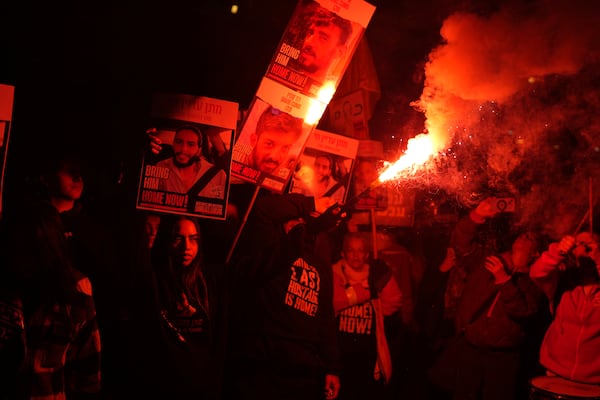 Relatives of hostages, held by Hamas in the Gaza Strip, protest outside of Israel's Ministry of Defense in Tel Aviv, Monday, Feb. 10, 2025, after the militant group announced it would delay hostage releases in the Gaza Strip after accusing Israel of violating a fragile ceasefire. (AP Photo/Ohad Zwigenberg)