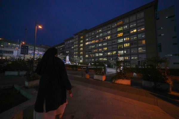 A nun prays for Pope Francis in front of the Agostino Gemelli Polyclinic, in Rome, Friday, March 7, 2025, where the Pontiff is hospitalized since Friday, Feb. 14. (AP Photo/Andrew Medichini)