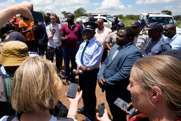 The Acting Provincial Commissioner of North West, Major General Patrick Asaneng, centre, speaks to journalists outside an abandoned gold mine, where miners were rescued from below ground, in Stilfontein, South Africa, Thursday, Jan. 16, 2025. (AP Photo/Themba Hadebe)