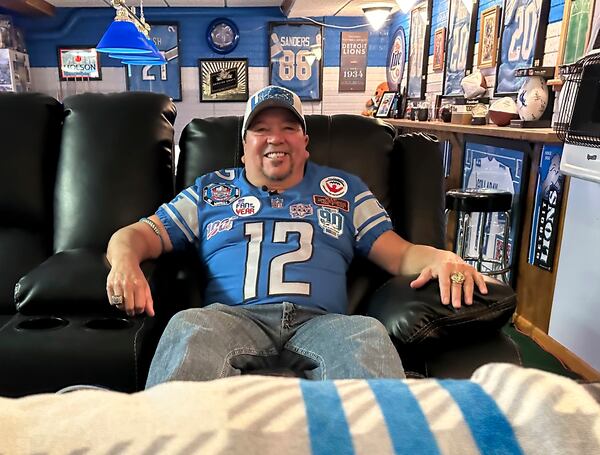 Detroit Lions fan Rob Gonzales sits in the chair he uses to watch Lions NFL football away games from the basement of his home Thursday, Jan. 16, 2025, in Frenchtown Township, Mich. (AP Photo/Mike Householder)