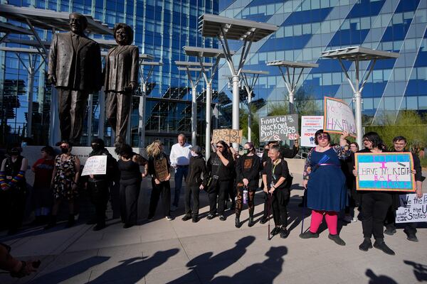 Protestors hold signs during a rally for a nationwide economic blackout Wednesday, Feb. 26, 2025, in Las Vegas. (AP Photo/John Locher)