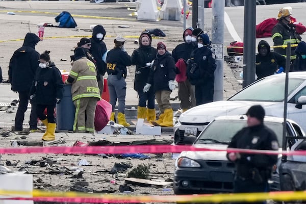 Investigators work the scene after a small plane crashed in Philadelphia, Saturday, Feb. 1, 2025. (AP Photo/Matt Rourke)