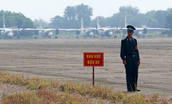 FILE- A Vietnamese soldier stands guard in front of military aircraft near a dioxin contaminated area while U.S. Defense Secretary Jim Mattis visits Bien Hoa air base in Bien Hoa, outside Ho Chi Minh City, Vietnam, Oct. 17, 2018. (Kham/Pool Photo via AP, File)